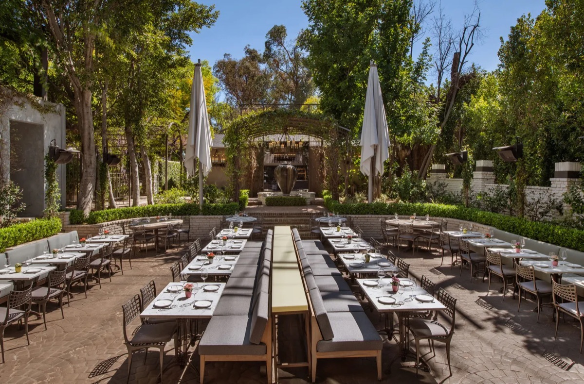Long tables set for a private dinner in a garden